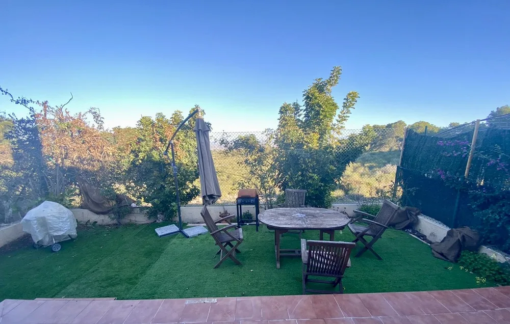 Private garden with table and parasol